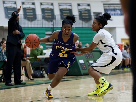 Ypsilanti High School senior Jasmine Jones drives against a Huron defender in the game on Monday, Feb. 25. Daniel Brenner I AnnArbor.com